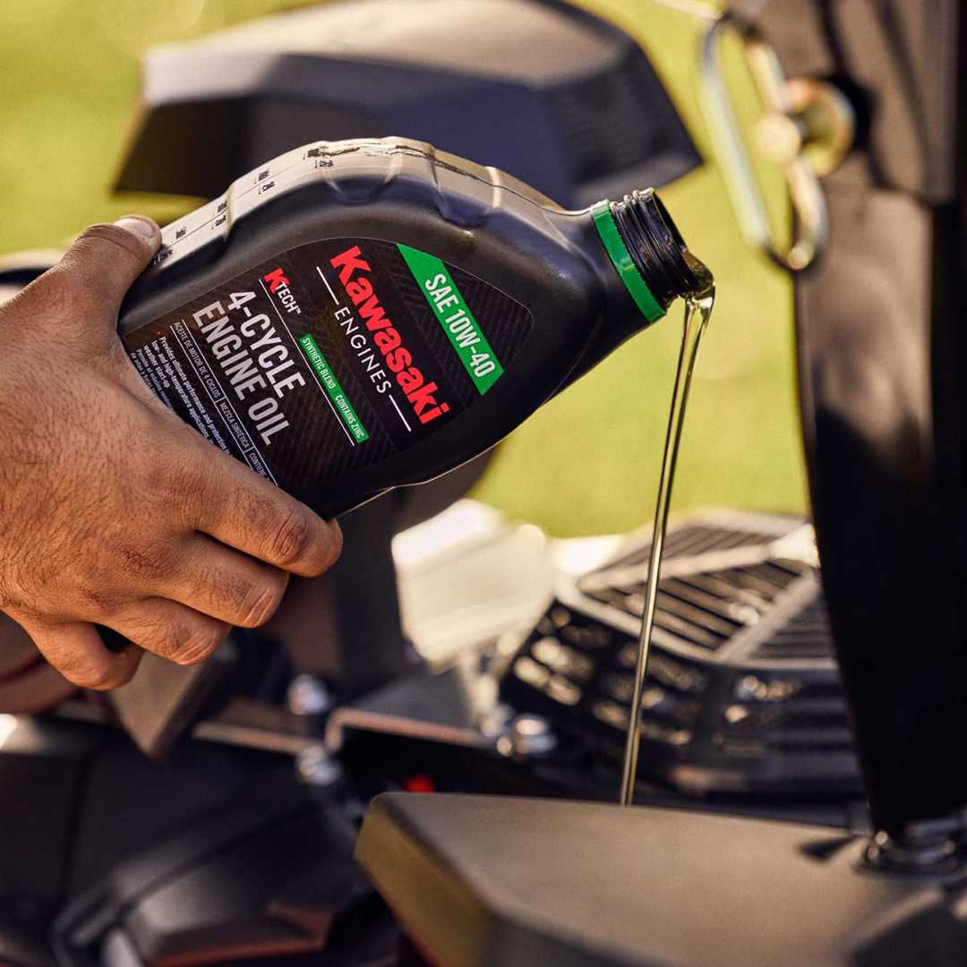 Hand pouring Kawasaki 4-Cycle Engine Oil into funnel.